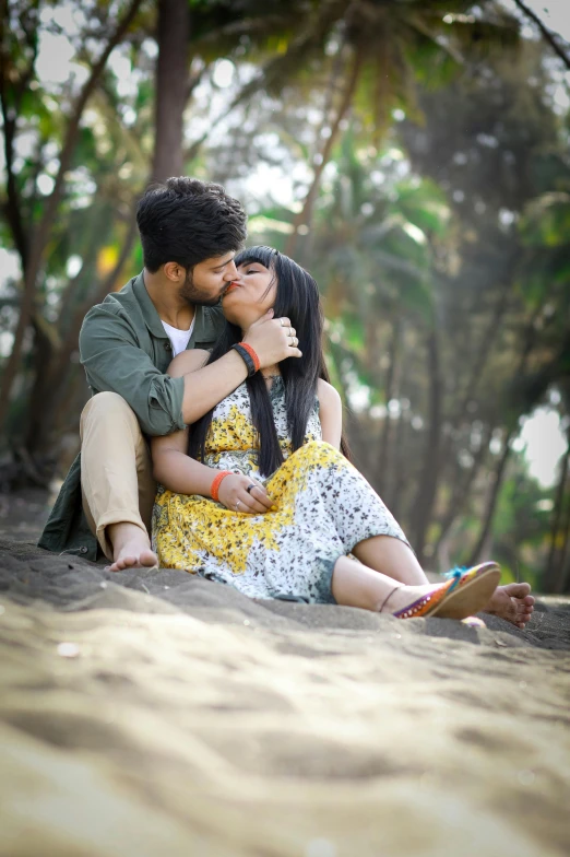 a man and woman sitting together on the ground