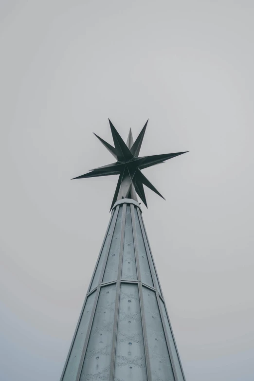 the top of a tall skyscr with a pointed star above