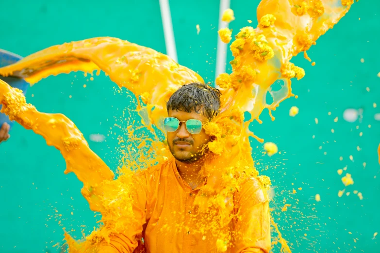 a man standing near a bunch of yellow powder