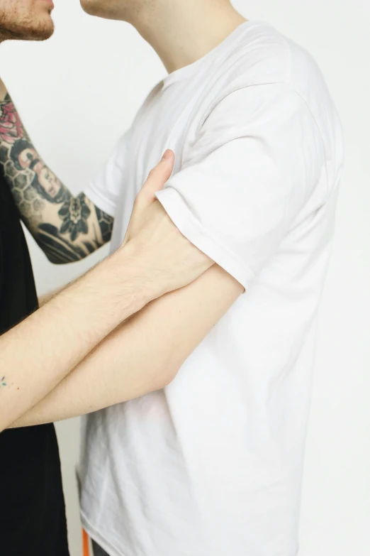 a tattooed man is putting soing on his arm