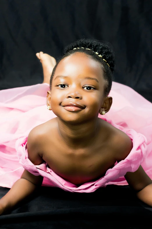 an african child wearing pink posing for a po