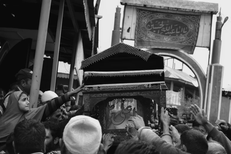 the people are waving their arms in a shrine