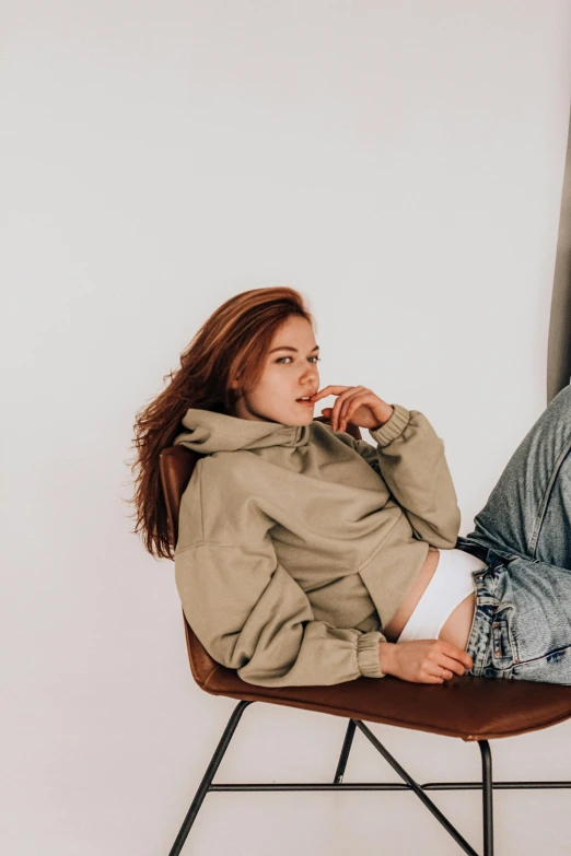 a woman sitting in a chair with her legs crossed