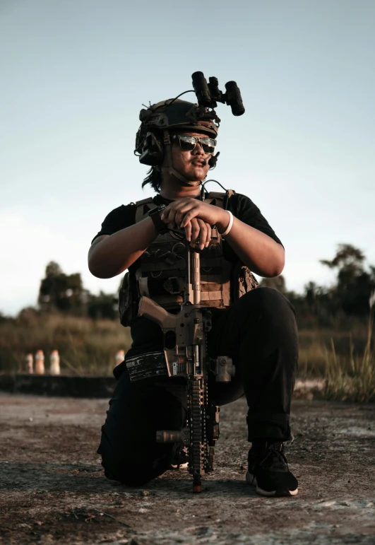 a man in a helmet and goggles holding an open rifle