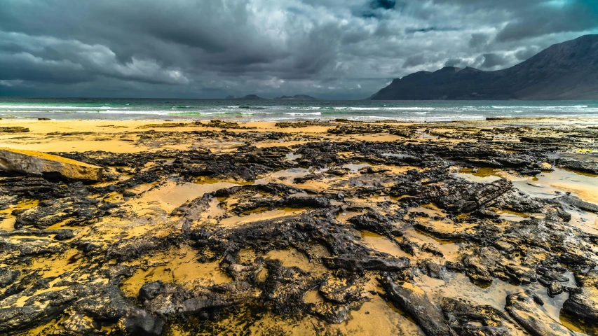 the sand is covered with various pieces of glass and rocks