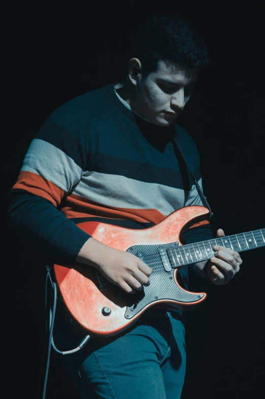 a man that is playing a guitar and holding a microphone