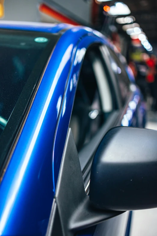 a close up of the side window of a blue car