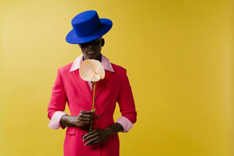 a man in a colorful suit and a blue hat