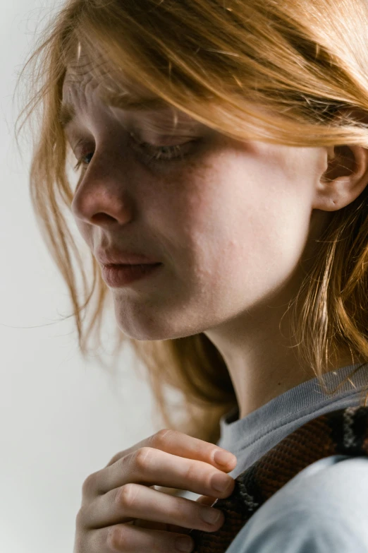 a young lady holds a snake around her neck