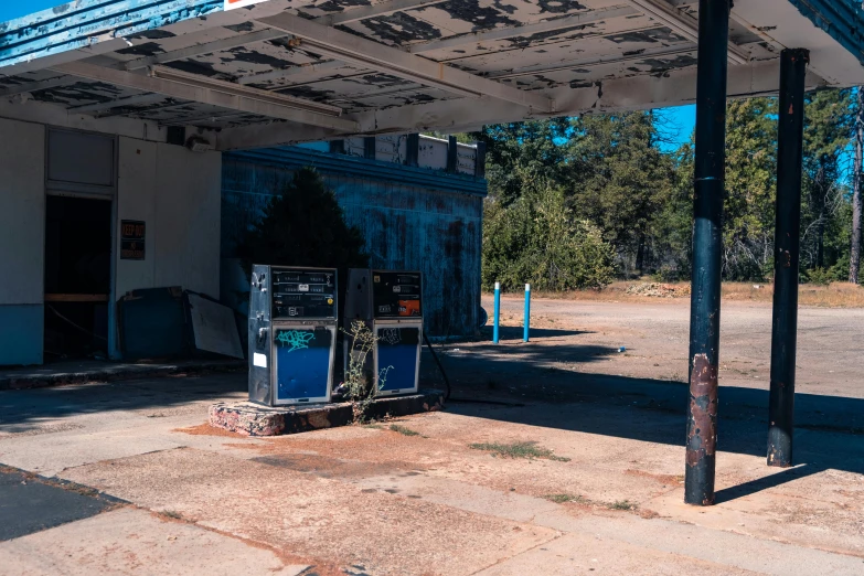 an old gas station sitting near some parking spots