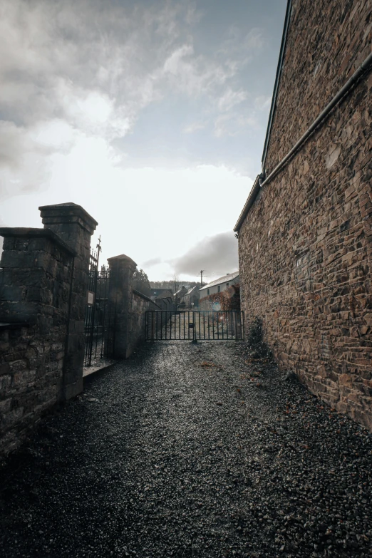 a black gate is attached to an old brick building