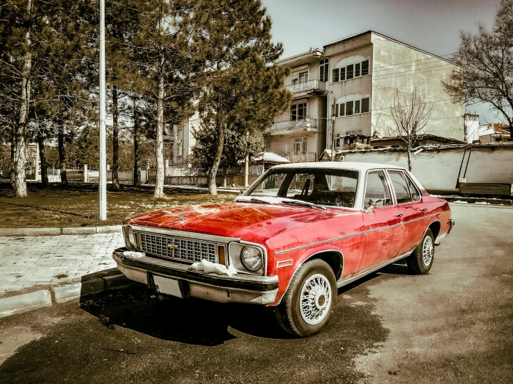 a red truck is sitting in a parking lot