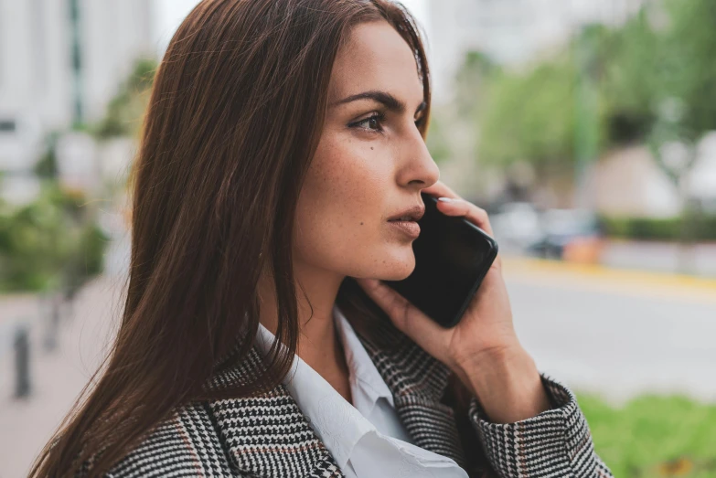 a woman talking on her cellphone outside