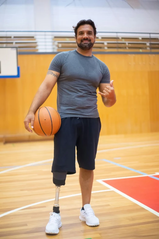 the basketball player is holding a ball in his left hand