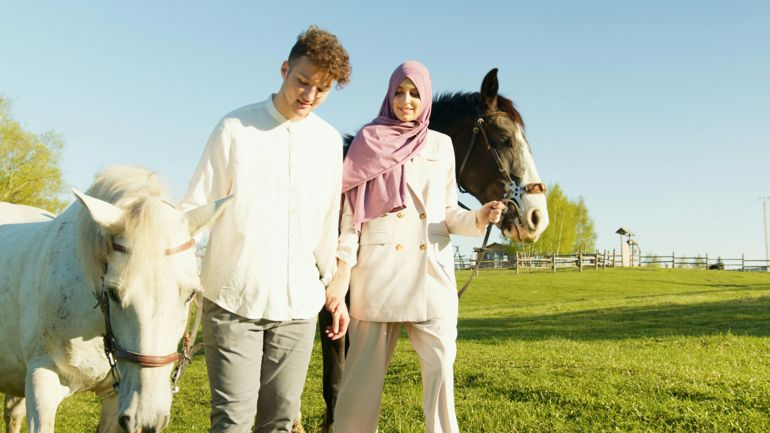 there is a man and woman standing next to the horses