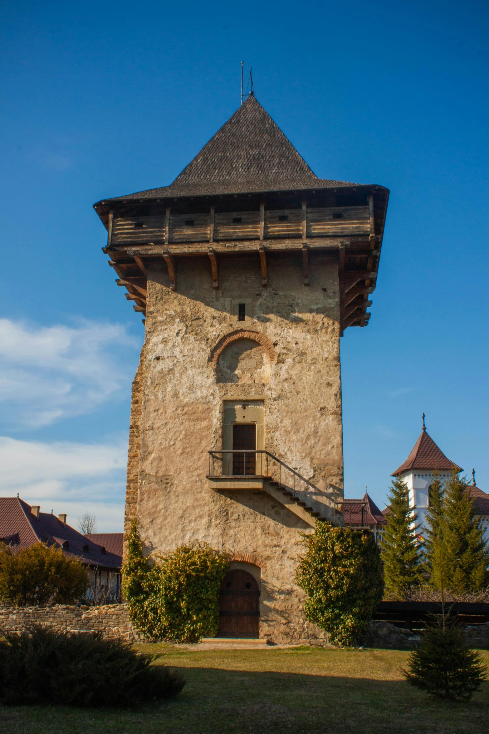 a tower with an opening is shown against a blue sky