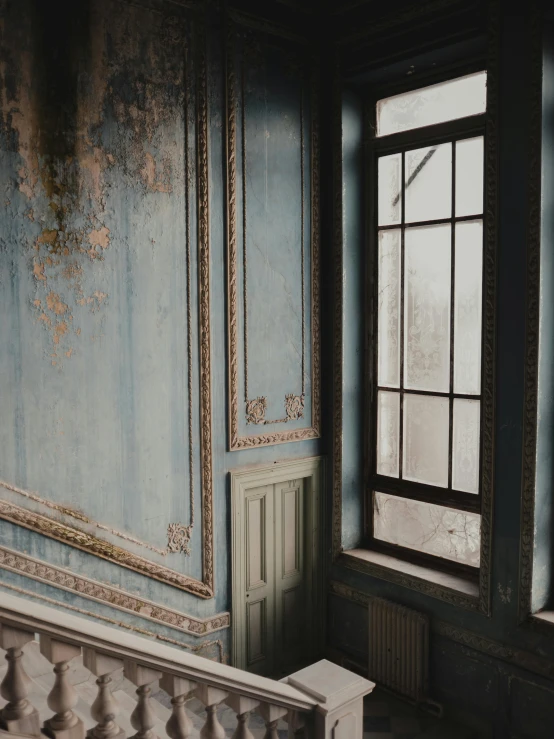 a room with a wooden floor and blue walls