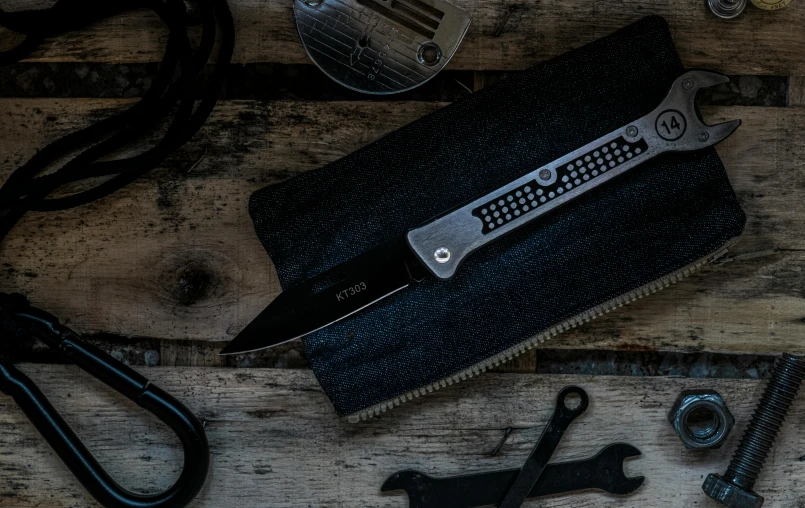 a wallet sitting on top of a wooden table with tools