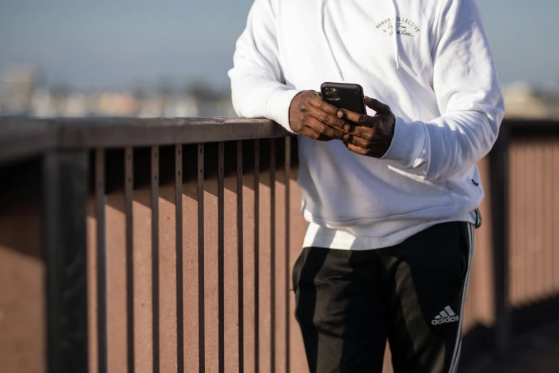 an african american man checks his cell phone