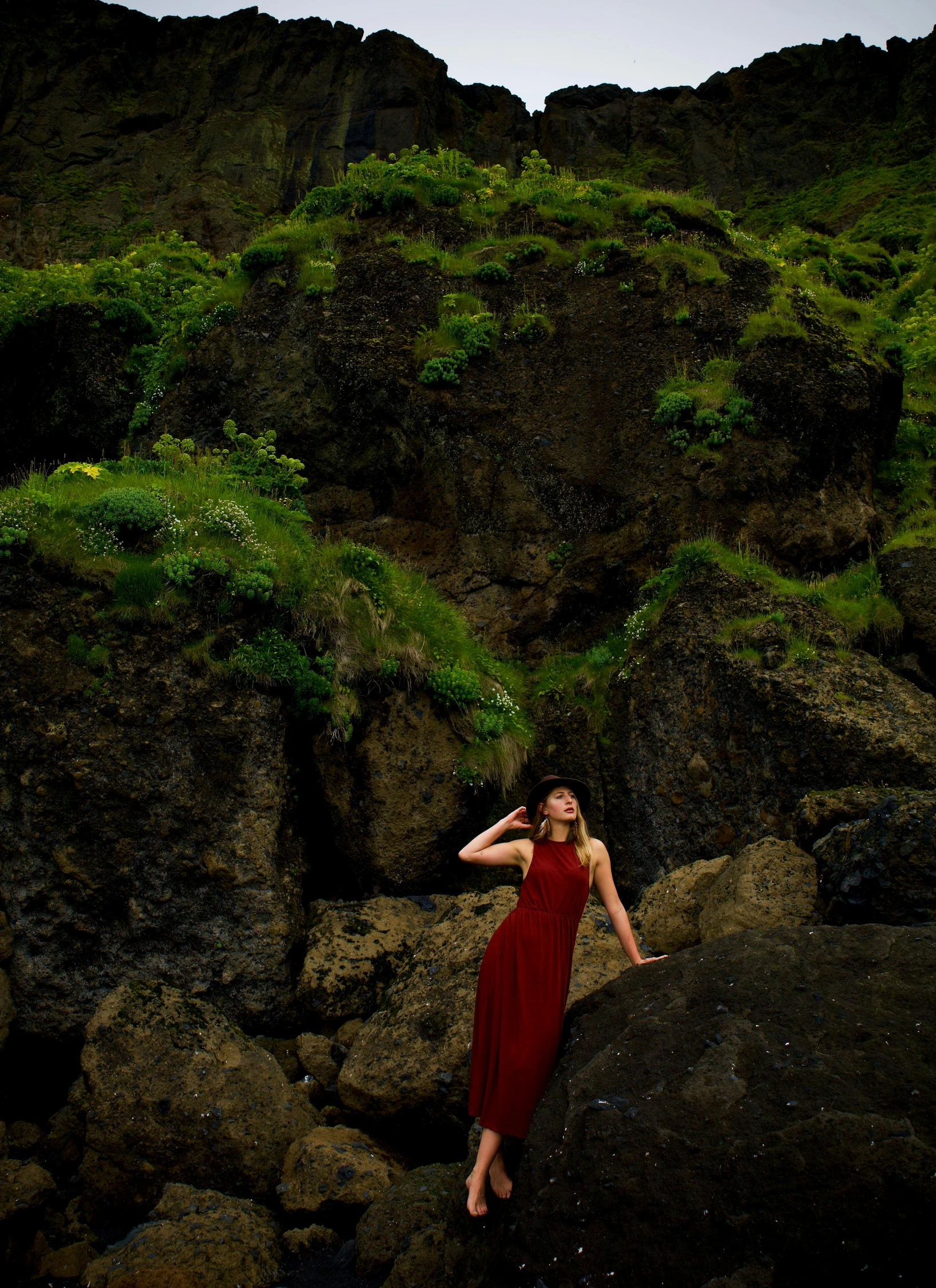 a woman poses on a rock formation