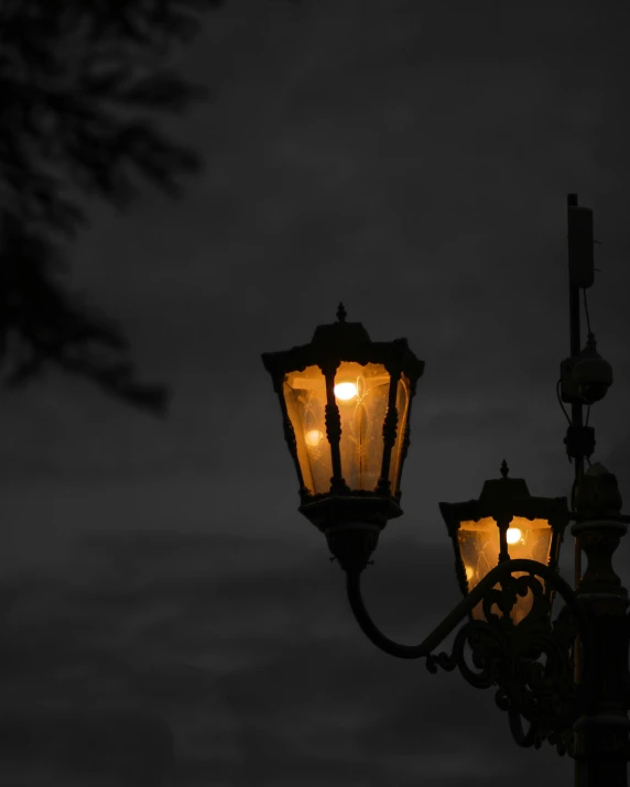 a streetlight in front of a cloudy sky