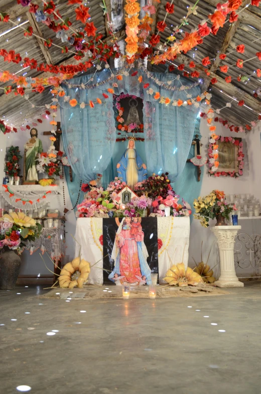 an altar with many decorations and flower arrangements