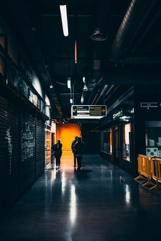 there is a long hallway with people in it