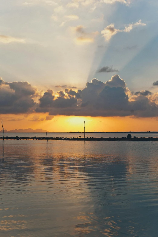 a large body of water next to a shore with boats