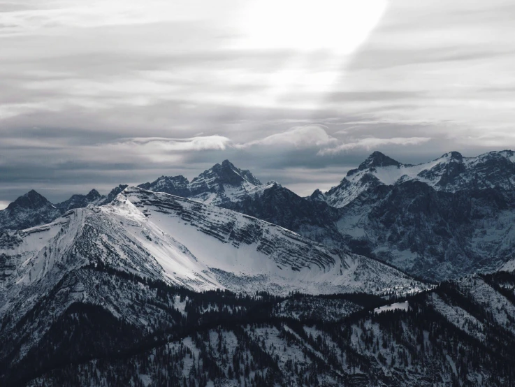 this is snow covered mountains under a gray sky