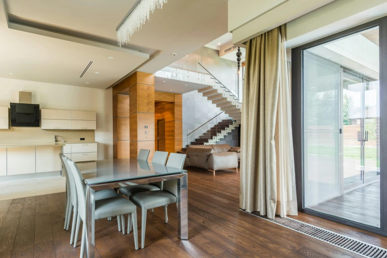 an open living room with a wooden floor and stairs