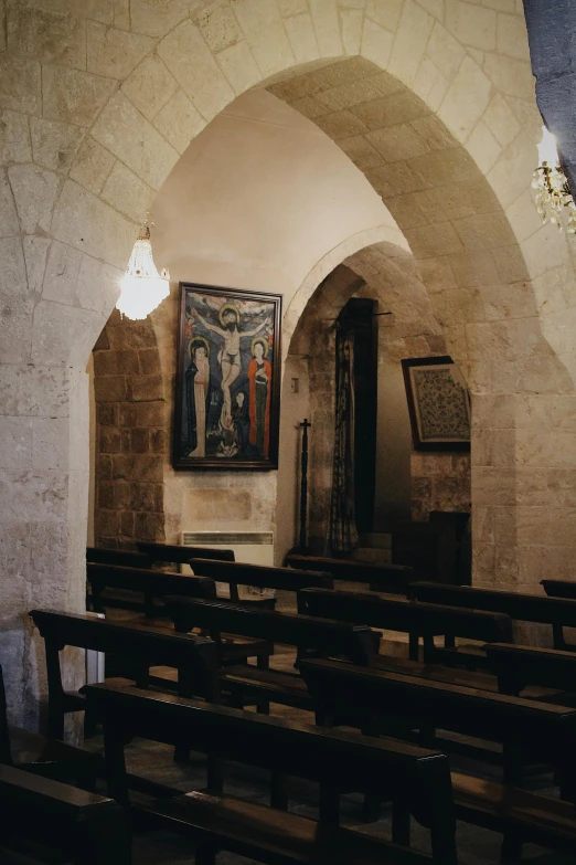 a church room with a couple of wooden pews