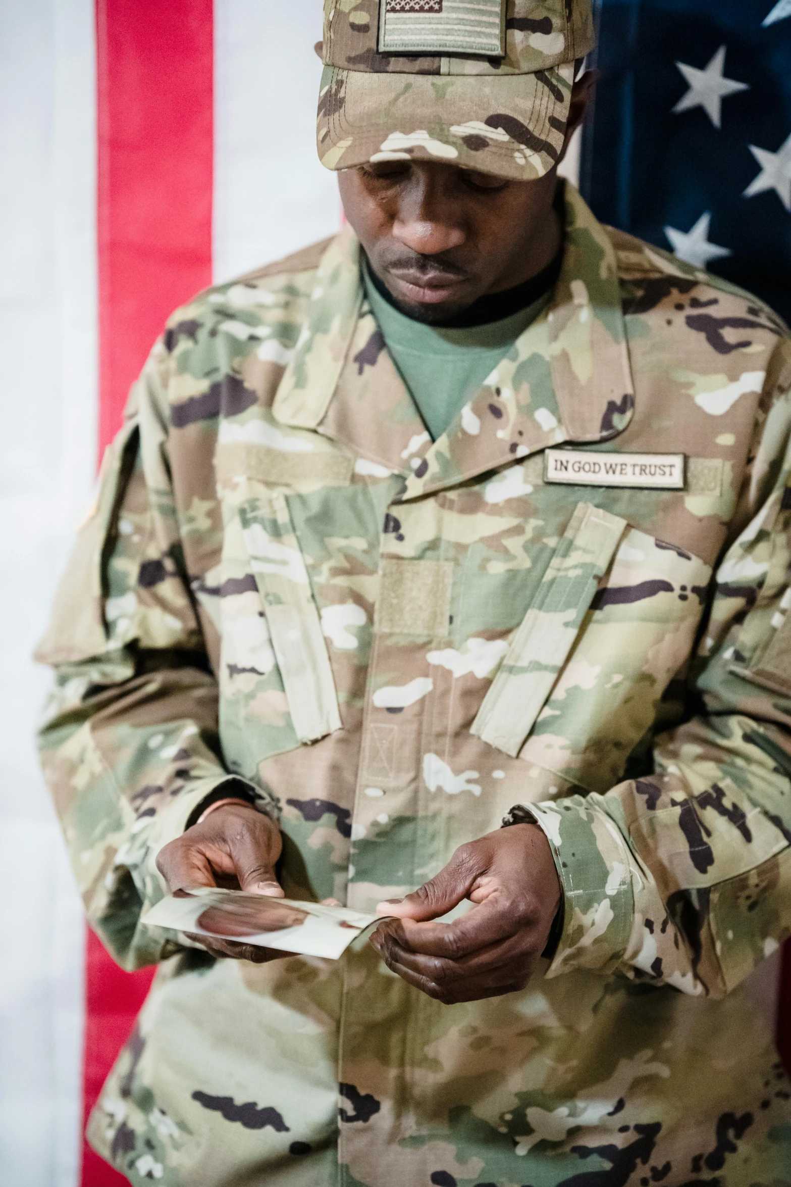 a man in uniform is looking at a piece of paper