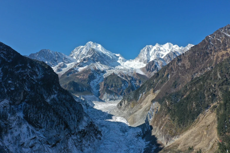 the snow covered mountains are high up on a clear day