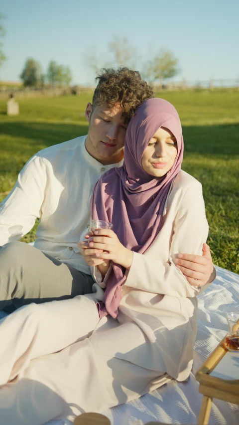 the young man and woman are sitting together