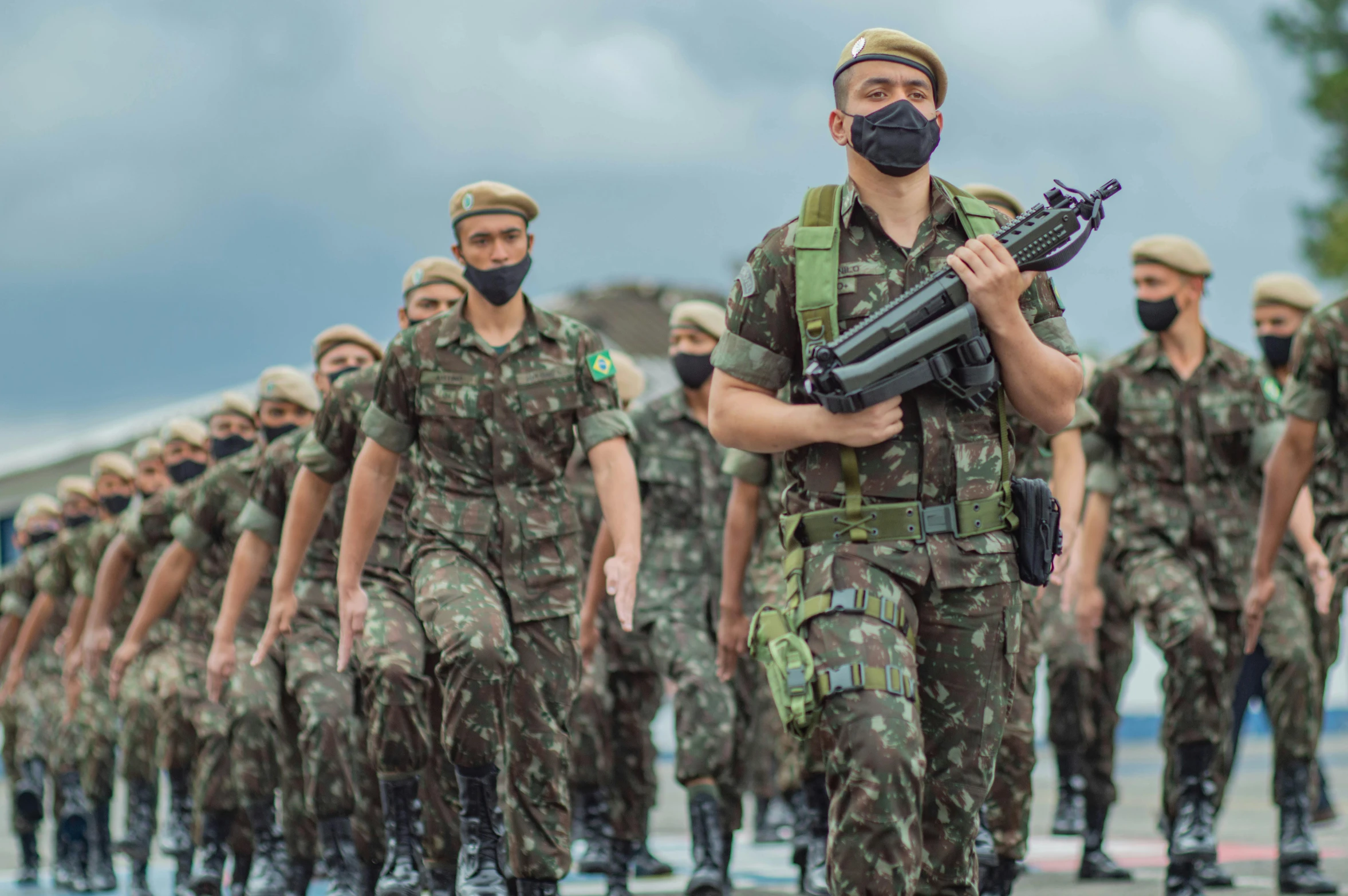 soldier in protective gear walking with rifle