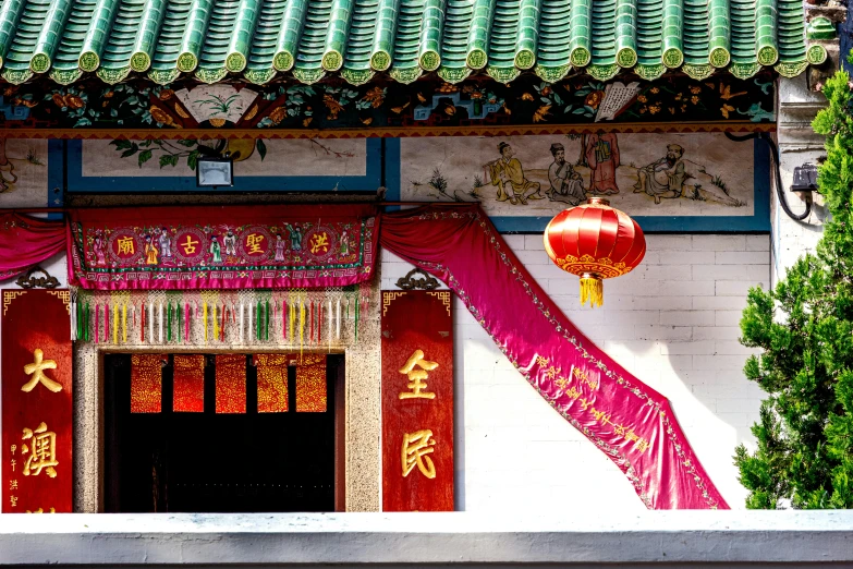 a building with red decorations outside the doorway