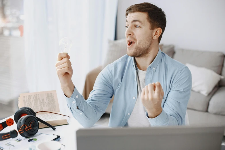 a man sitting at a table with his mouth open