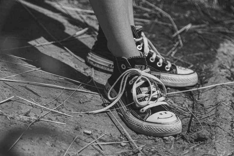 the bottom view of two converse sneakers on the ground