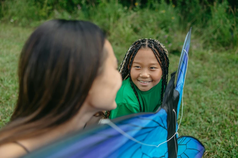 the girl is in the grass with her kite