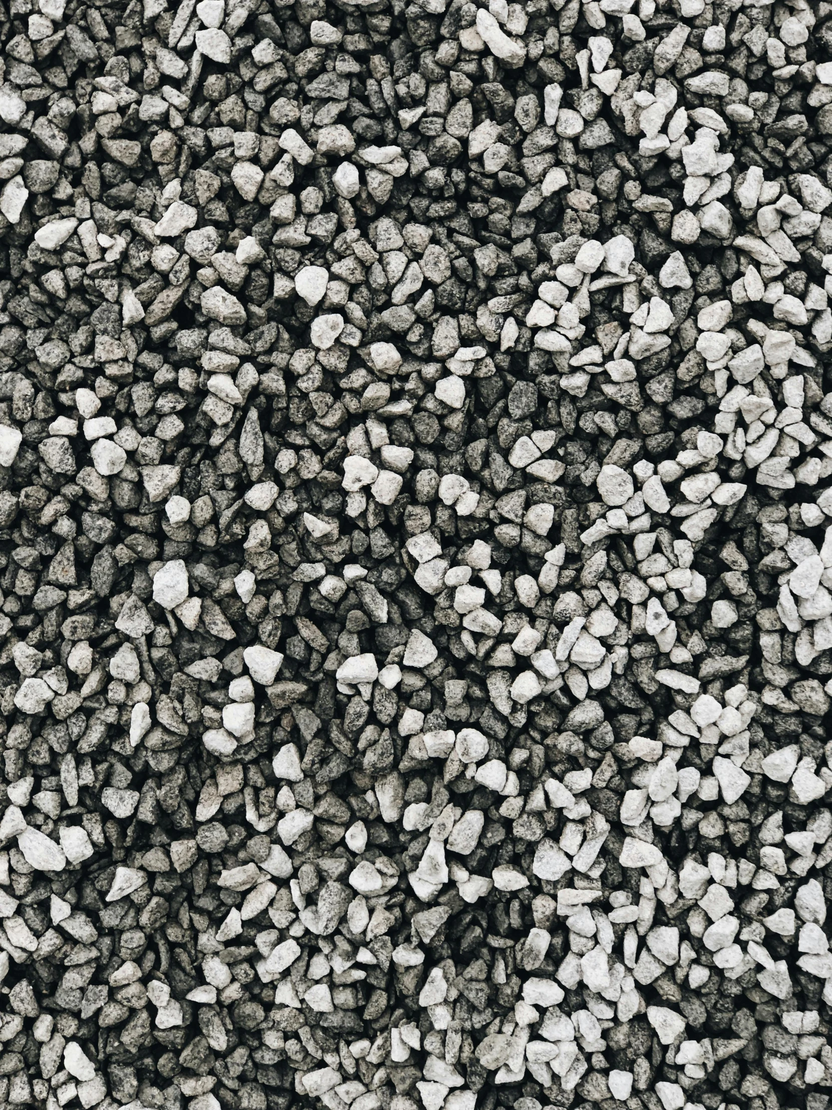 a black and white background with many small rocks