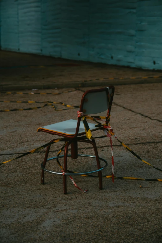 a plastic chair sitting next to a wall