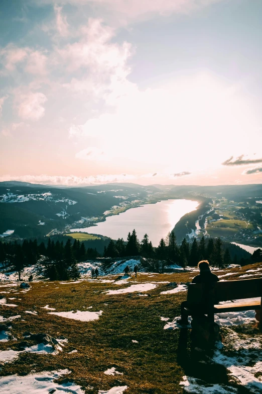 a man sitting on top of a snow covered slope