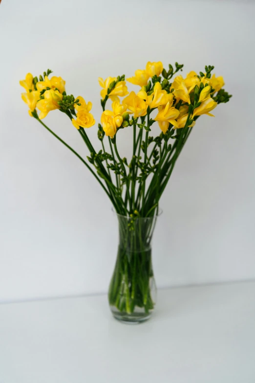 small bouquet of yellow flowers in glass vase