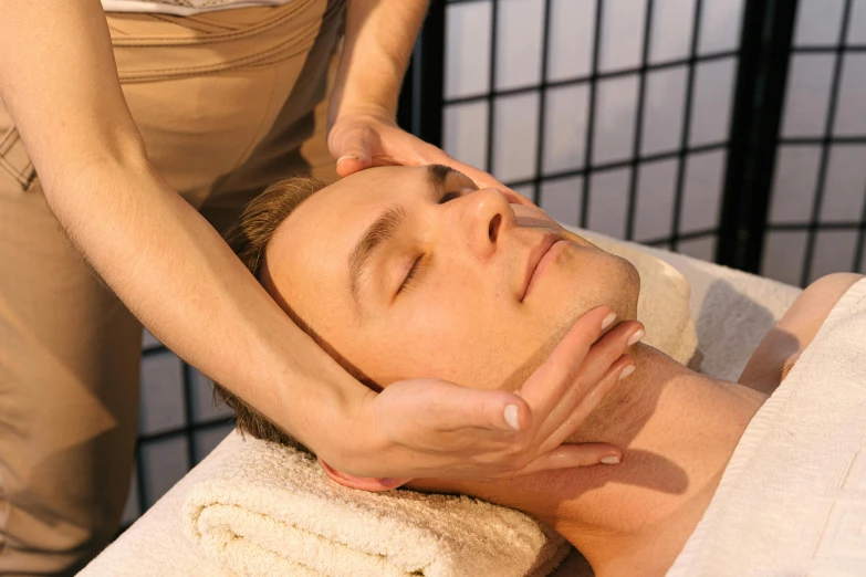 a man getting a facial massage on his face