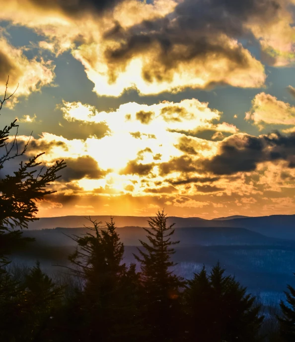 sunset from atop a mountain with many clouds