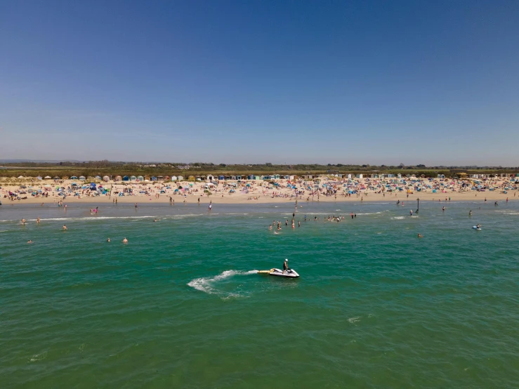 there are many people at the beach swimming and having fun