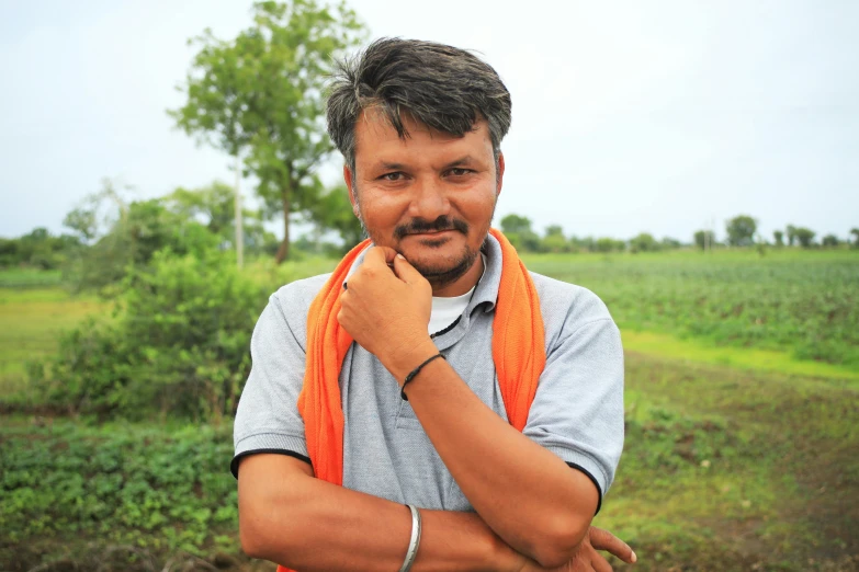 a man that is wearing a tie and looking straight ahead