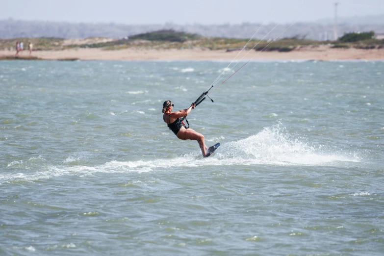 a man water skiing is wearing shorts and a shirt