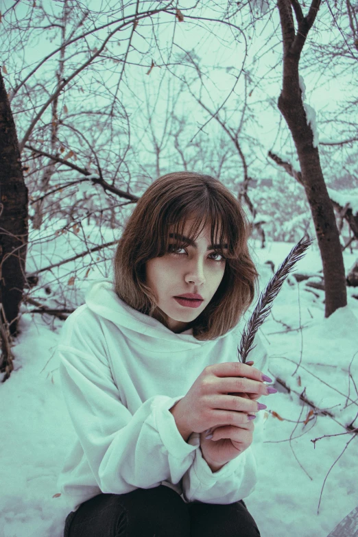 a woman holds a piece of paper in the snow