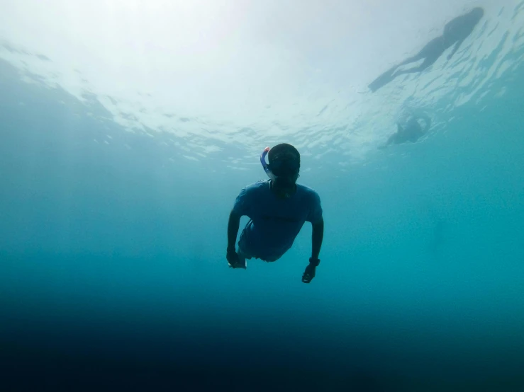 a man is floating in the water in his wetsuit